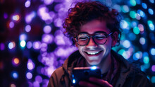 Young Guy On His Phone Smiling At Purple Light