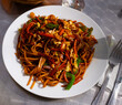 © JackF - Indonesian style spicy fried noodle dish with sliced onion, pepper, carrot, meat and egg..