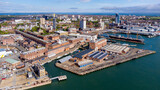 Fototapeta Londyn - Aerial view of Portsmouth Historic Dockyard and the Royal Navy's ancient HMS Warrior warship on the English Channel coast in the south of England, United Kingdom