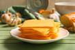 © Pixel-Shot - Plate with slices of tasty processed cheese on table