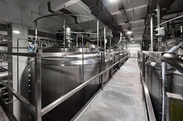 Metal ground near large cisterns for fermented milk products