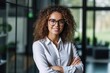 Smiling confident stylish young woman standing at the office. Young businesswoman, curly-haired lady executive business leader manager looking at camera arms crossed, generative AI