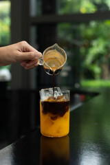 Wall Mural - a cup of Ice coffee with orange