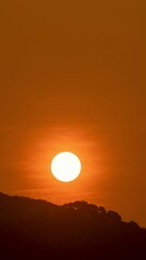 Wall Mural - timelapse of dramatic sunrise with orange sky in a sunny day.