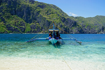 Wall Mural - traditional wooden outrigger boats on palawan island