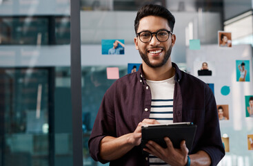 Technology, portrait of happy businessman with tablet and standing in office at work. Social media or networking, Corporate and creative young man with mobile device checking emails at workplace