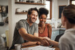 © A. Frank/peopleimages.com - Love, handshake and couple with a financial advisor, consultation and discussion for investments. Partners, man and woman with a consultant, home and conversation for advice, help and shaking hands
