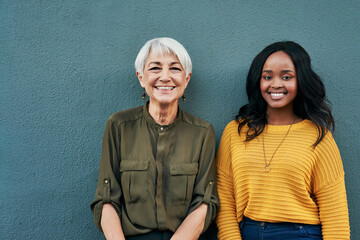 Poster - Happy, diversity and portrait of women on a blue background for success, happiness and work. Smile, business and a young and senior employee standing on a wall for a professional career profile