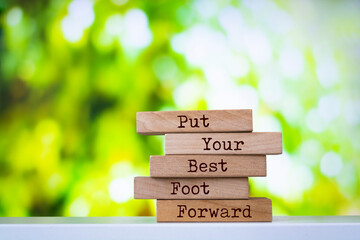 Wooden blocks with words 'Put Your Best Foot Forward'. Inspirational motivational quote