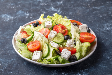 Wall Mural - Salad with vegetables, feta cheese and olives. Healthy and diet food concept.