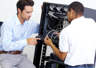 Wall Mural - Cables, programming and men with server. talking and cyber security in the workplace. Male employees, coworkers and staff with coding, electrician and technician with communication and tech support