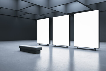 Perspective view on a bench on concrete floor in front of three blank white illuminated screens with place for your advertising text on dark wall background in gallery hall. 3D rendering, mock up