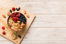 Cooking A Wholesome Breakfast. Granola With Various Dried Fruits And Nuts In A Bowl. The Concept Of A Healthy Dessert. Flat Lay, Top View With Copy Space