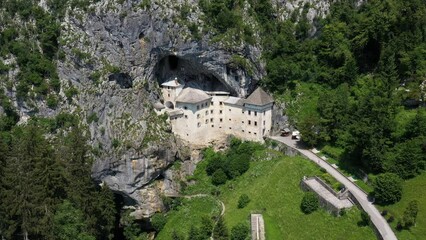 Canvas Print - Predjama Castle in Slovenia, Europe. Renaissance castle built within a cave mouth in south central Slovenia, in the historical region of Inner Carniola. It is located in the village of Predjama. Drone