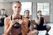 © Grady Reese/peopleimages.com - Fitness, kettlebell and personal trainer doing a workout with a group for strength training in a gym. Sports, challenge and female coach doing a exercise with weights with people in a wellness center