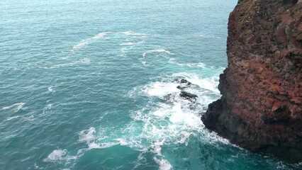 Wall Mural - View from above the waves crashing against the rocks