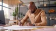 © GustavsMD - African Male Architect Working on Blueprints in Office. Generative AI.