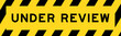 Yellow and black color with line striped label banner with word under review