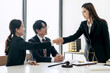 Female lawyer shaking hands with client after discussing deal of