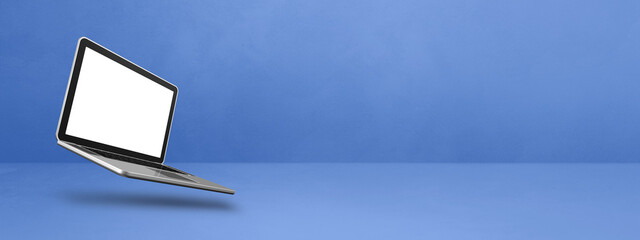 Poster - Floating computer laptop isolated on blue. Horizontal banner background