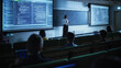 © Gorodenkoff - Diverse Multicultural Students Studying in University Room, Listening to a Young Female Professor Explaining Big Data and Artificial Intelligence Research Project. Computer Science Education