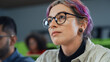 Close Up Portrait of a Creative Female Student with Short Colored Hair. Young Woman in Glasses Studying in University with Diverse Multiethnic Classmates, Sitting and Listening to a Lecture