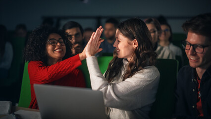 Leinwandbilder - Diverse Happy Students Having a Conversation in University Classroom, Working on a Shared Research Project on a Laptop Computer. Young Female and Male High Five to Celebrate a Successful Result