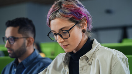 Aufkleber - Portrait of a Creative Female Student with Short Colored Hair. Young Woman in Glasses Studying in University with Diverse Multiethnic Classmates, Sitting and Listening to a Lecture