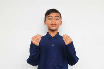 Indonesia muslim kid is praying and raising his hand, religious kid concept