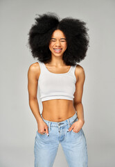 Poster - Portrait of smiling woman with braces on teeth and afro hairstyle isolated on gray background