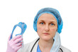 A doctor with a wounded face removes goggles after working in the hospital, isolated on a white background. A nurse in a white coat and a medical beret with marks on her face