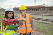 © reewungjunerr - Two engineer working at train station,Work together happily,Help each other analyze the problem,Consult about development guidelines
