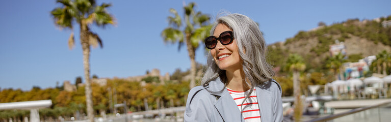 Wall Mural - Happy and healthy woman enjoying good day outdoors