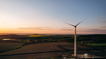 View of wind farm or wind park produce electricity on  sunset. Sustainable electricity production.	