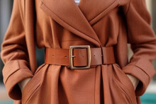 Female Figure In A Stylish Brown Fancy Autumn Coat With Leather Belt. Fancy Street Style Clothing Concept.