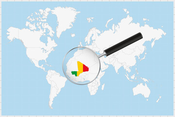 Wall Mural - Magnifying glass showing a map of Mali on a world map.