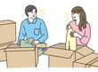 © koumaru - 段ボール箱の前で荷造りする男女のカップル