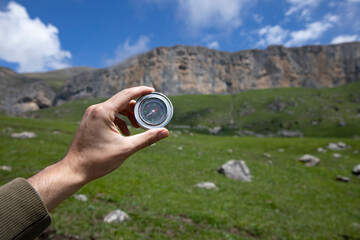 Wall Mural - Man with compass in hand on mountains road