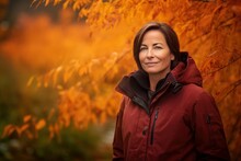 Environmental Portrait Photography Of A Pleased Woman In Her 40s Wearing A Warm Parka Against An Autumn Foliage Background. Generative AI