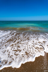 Wall Mural - Sea surf on the beach of Spain in spring. High quality photo