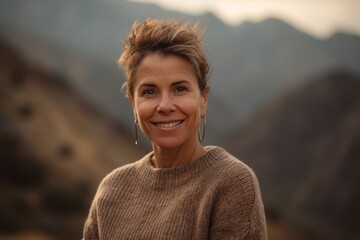 Wall Mural - Portrait of a smiling middle-aged woman in the mountains.