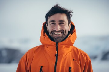 Wall Mural - Portrait of a smiling man in a yellow jacket on the background of a frozen lake