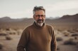 © Anne-Marie Albrecht - Portrait of senior man with eyeglasses standing in the desert