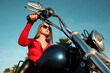 Beautiful young woman riding motorcycle on sunny day, low angle view