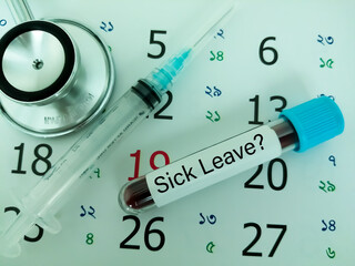 Sticker - Blood sample in a tube with label sick leave on a monthly planner appointments. Blood tests labeled sick leave