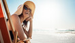 © Grady Reese/peopleimages.com - Beach, summer and mockup with a woman laughing while sitting on a chair by the ocean or sea on vacation. Blue sky, view and horizon over water with an attractive young female tourist feeling happy