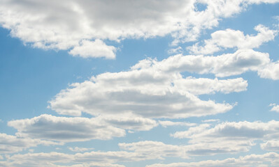 blue sky with white fluffy clouds against the sky