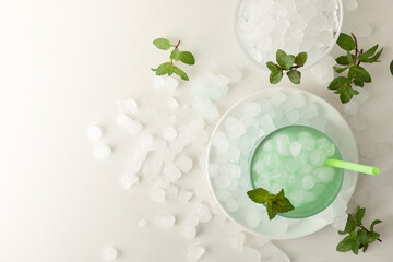 Wall Mural - Background with mint drink on white table filled with ice