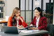 © Nuttapong punna - Two Asian businesswoman discuss investment project working and planning strategy with tablet laptop computer in office.
