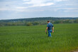© viktoriia1974 - A young agronomist inspects the crops. Yield increase. The problem of world hunger. Organic cultivation of crops.Agriculture